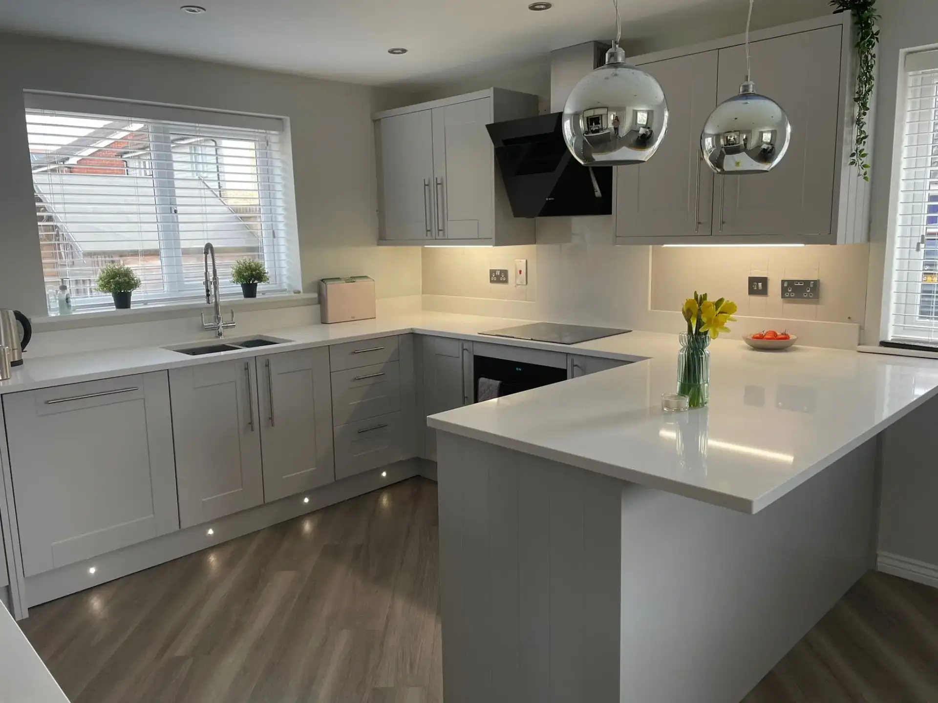 Modern Kitchen With Grey Cabinets And Flowers.