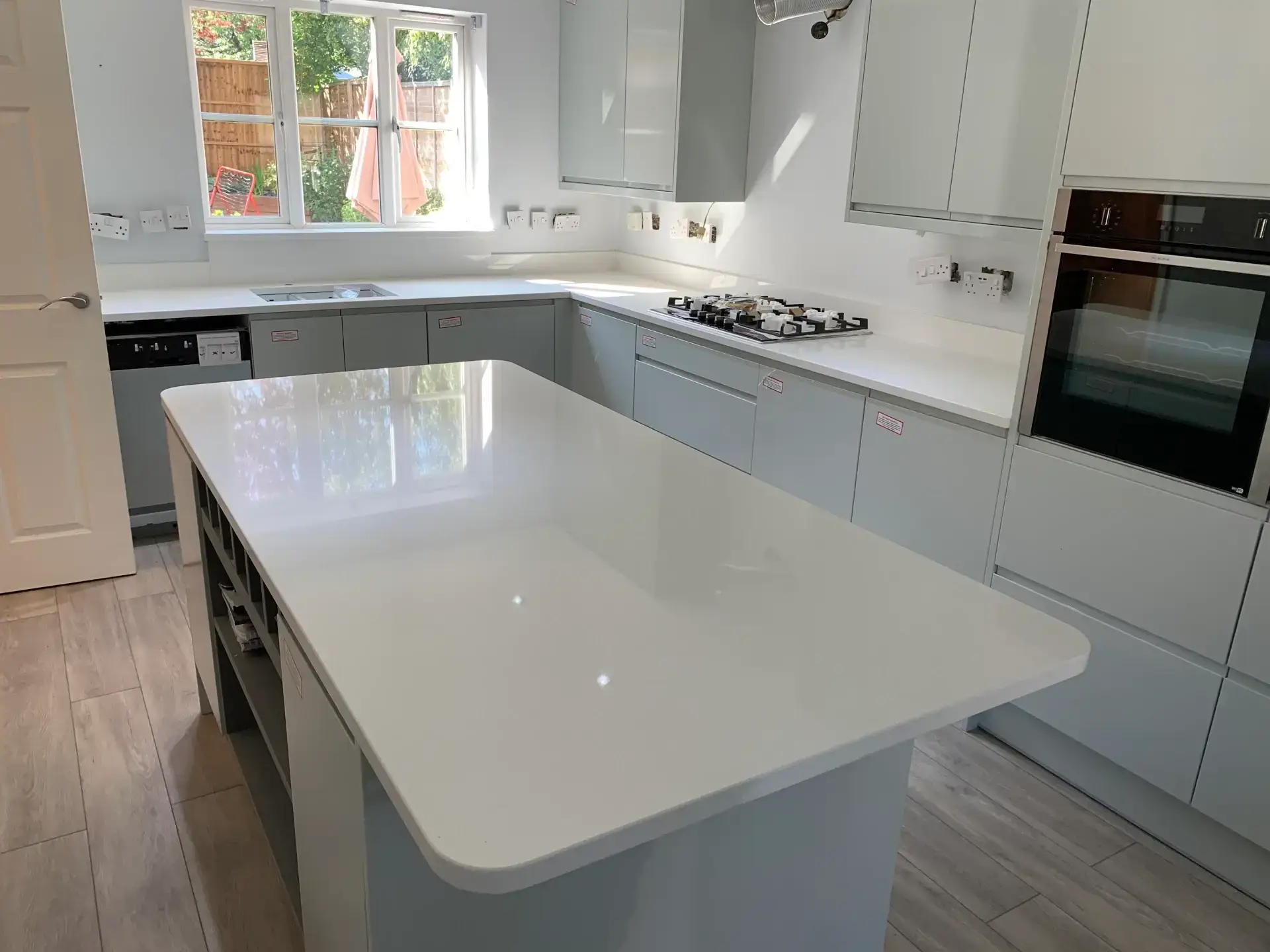 Modern Kitchen With White Surfaces.