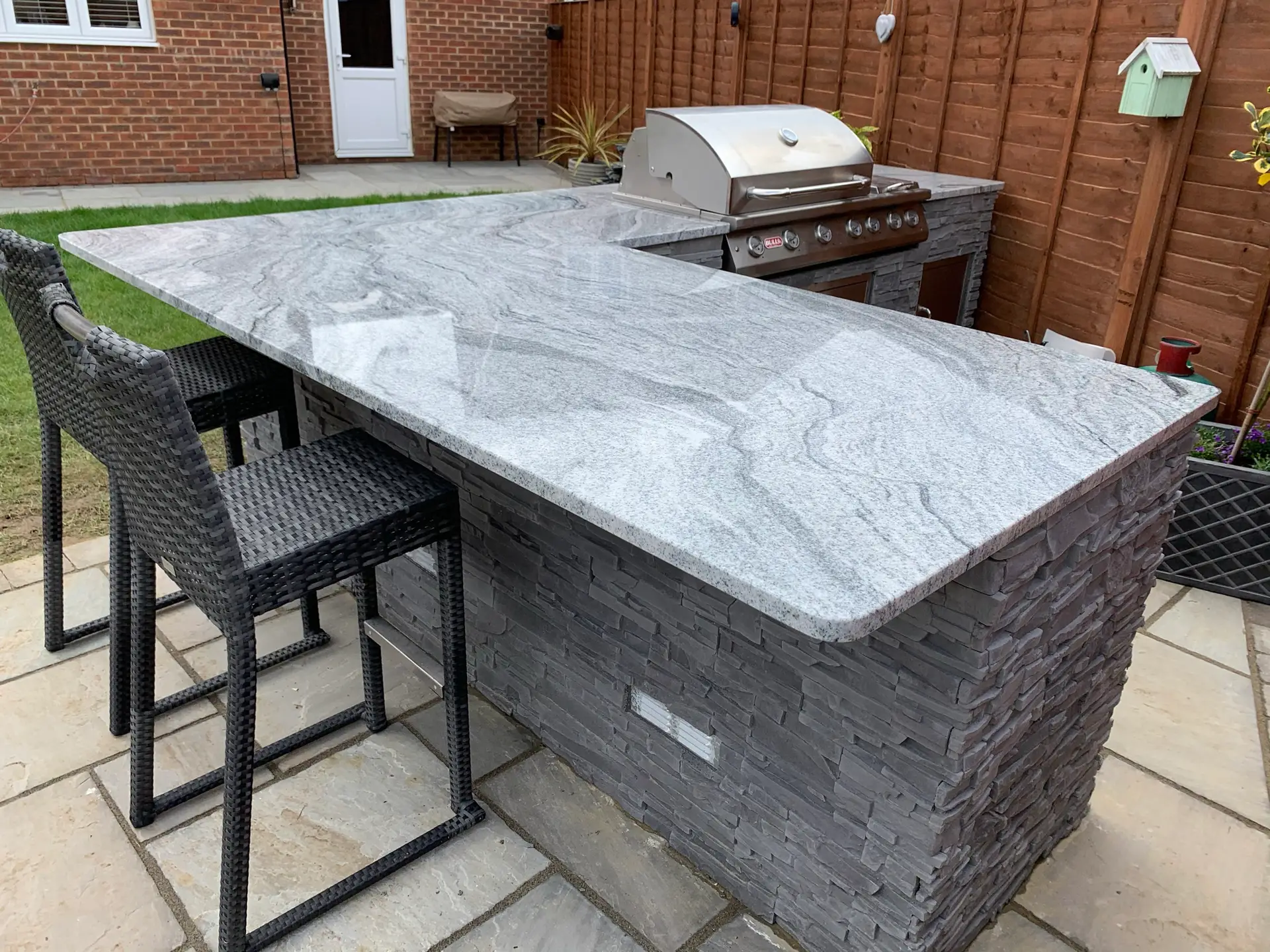 Outdoor Kitchen With Granite Countertop.