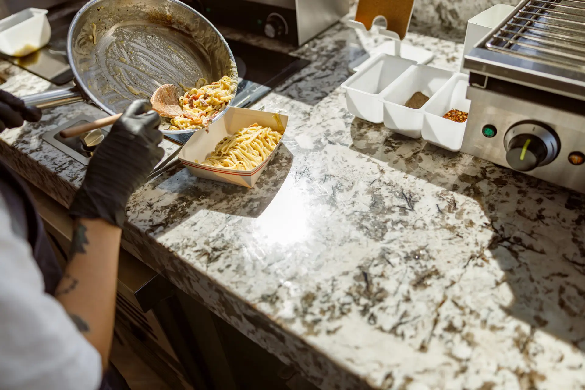 Talented Chef Skillfully Preparing A Delicious Meal On A Beautiful Granite Countertop